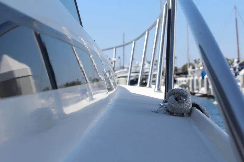 Slide: The Image of Close-up of a 1996 Trojan 440 Express yacht railing and deck, docked at a marina. - 10