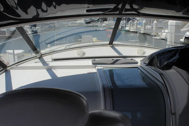 Slide: The Image of 1996 Trojan 440 Express yacht interior with marina view through windshield. - 16