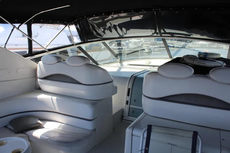 Slide: The Image of Interior of a 1996 Trojan 440 Express yacht with white leather seating. - 17