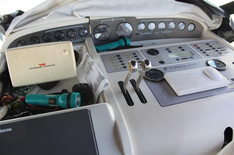 Slide: The Image of Control panel of a 1996 Trojan 440 Express boat with various instruments and equipment. - 18