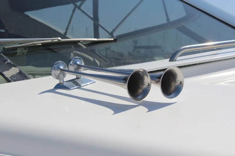Slide: The Image of Chrome horns on a 1996 Trojan 440 Express boat deck. - 19