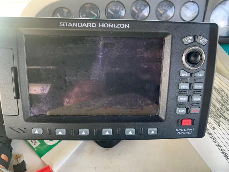 Slide: The Image of Standard Horizon GPS chart plotter on a 1996 Trojan 440 Express boat dashboard. - 22