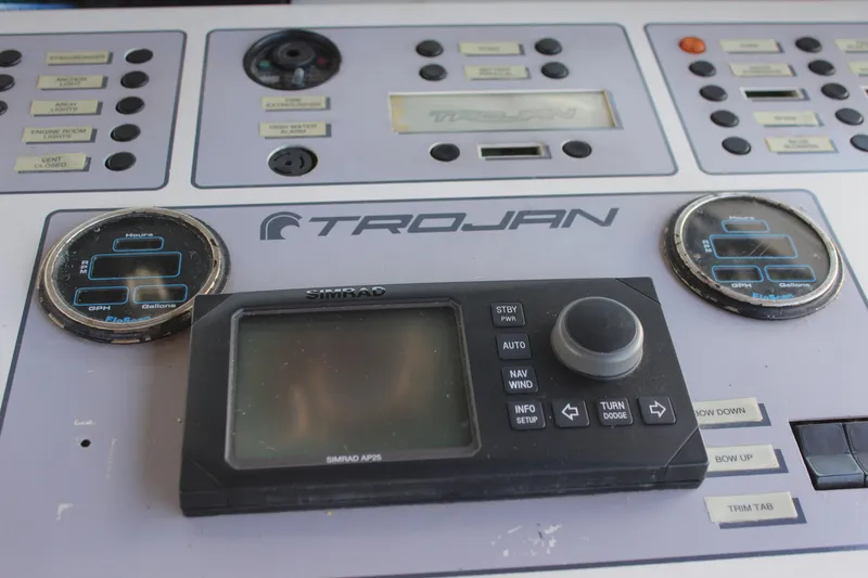 Slide: The Image of Control panel of a 1996 Trojan 440 Express boat with navigation instruments. - 23