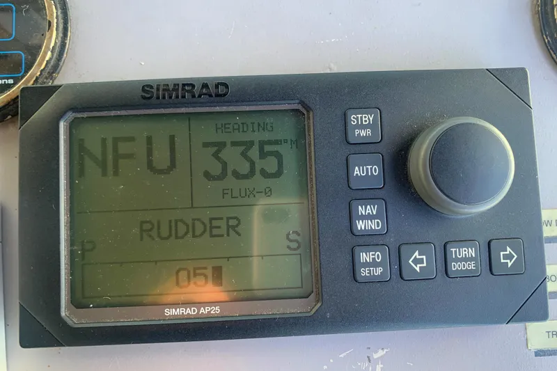 Slide: The Image of Simrad AP25 autopilot display on 1996 Trojan 440 Express, showing heading 335 degrees. - 24