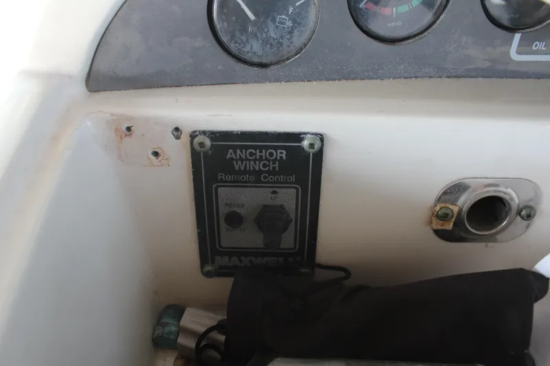 Slide: The Image of Control panel of a 1996 Trojan 440 Express boat with anchor winch remote. - 26