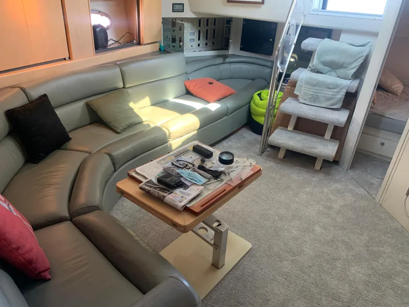 Slide: The Image of Luxurious interior of a 1996 Trojan 440 Express yacht with plush seating and modern amenities. - 27