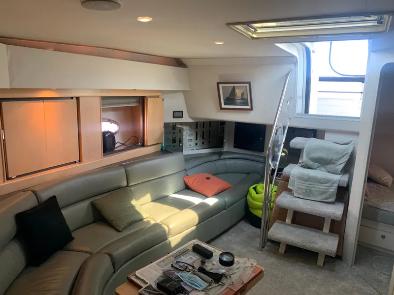 Slide: The Image of Interior of a 1996 Trojan 440 Express yacht with cozy seating and modern decor. - 30