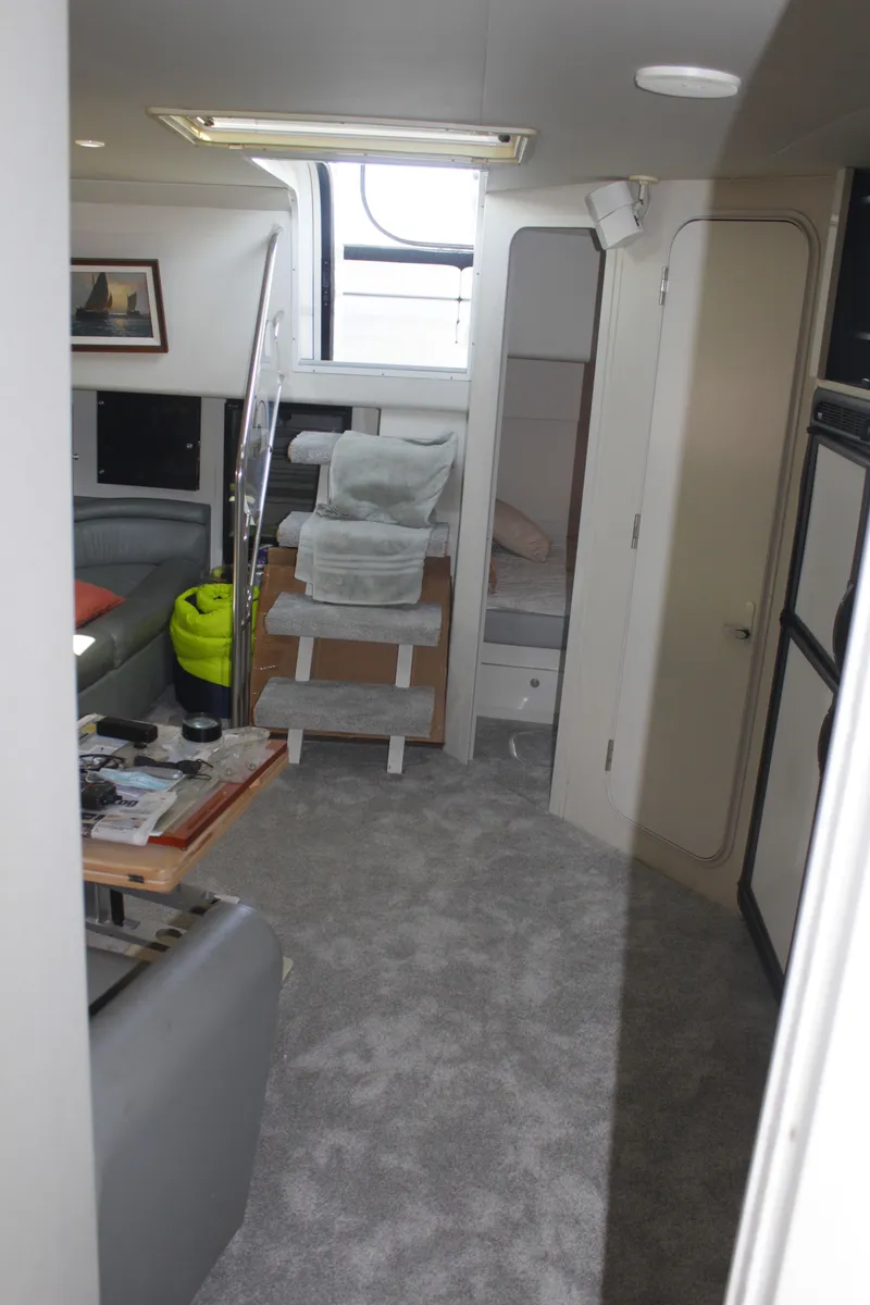 Slide: The Image of Interior of 1996 Trojan 440 Express yacht with modern furnishings and carpeted flooring. - 35