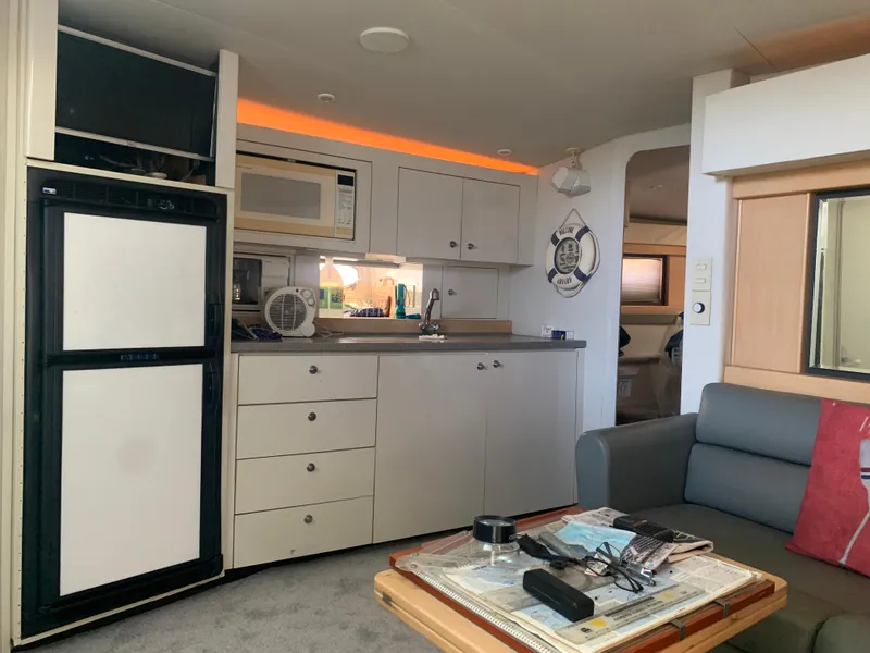 Slide: The Image of Interior of a 1996 Trojan 440 Express yacht with kitchenette and seating area. - 40