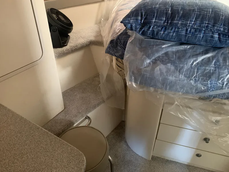 Slide: The Image of Interior of 1996 Trojan 440 Express yacht with bed, fan, and storage. - 45