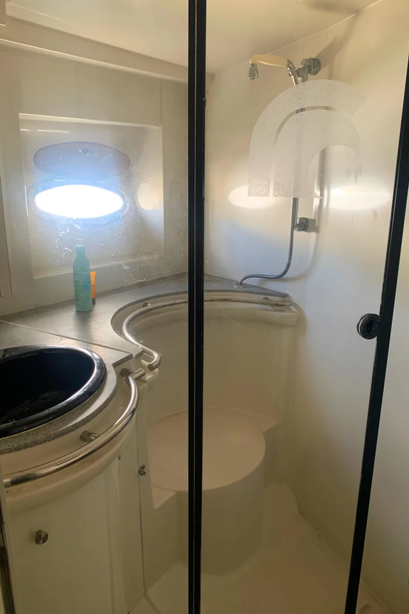 Slide: The Image of Bathroom interior of 1996 Trojan 440 Express yacht with shower and sink. - 48
