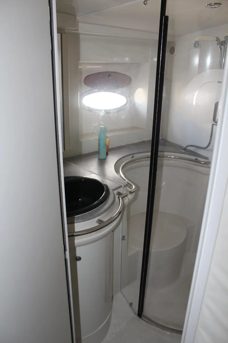 Slide: The Image of Bathroom interior of a 1996 Trojan 440 Express yacht with modern fixtures. - 49
