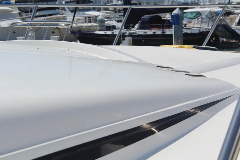 Slide: The Image of 1996 Trojan 440 Express yacht, sleek design, docked in marina. - 7
