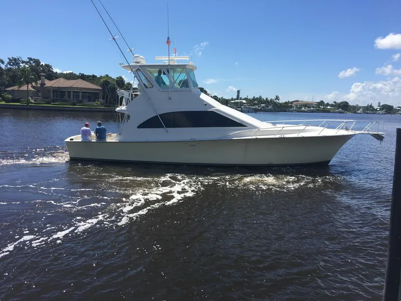 Slide: The Image of 1999 Ocean Yachts 48 Super Sport docked at a marina. - 2