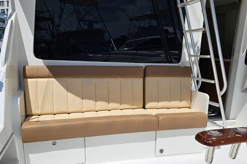 Slide: The Image of 1999 Ocean Yachts 48 Super Sport boat seating area with ladder. - 3