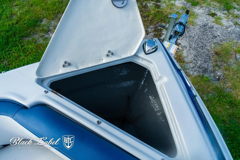 Slide: The Image of 2024 Crownline 260 XSS boat storage compartment open, showcasing interior space. - 10