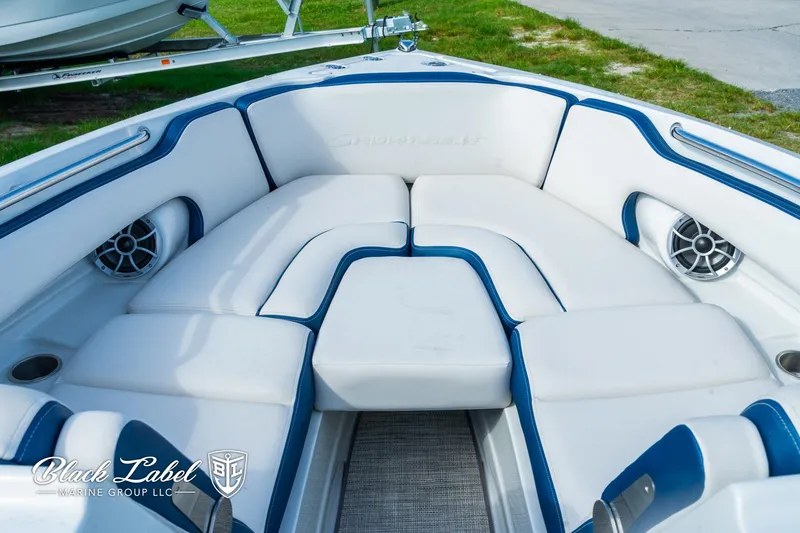 Slide: The Image of 2024 Crownline 260 XSS boat interior with white and blue seating. - 11