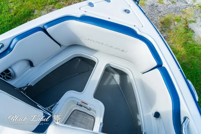 Slide: The Image of 2024 Crownline 260 XSS boat interior with blue and white seating, Black Label Marine Group. - 12