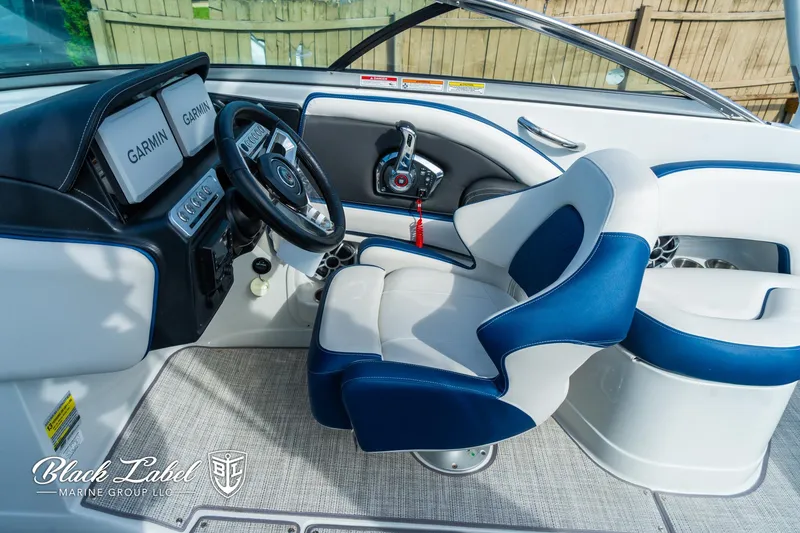 Slide: The Image of 2024 Crownline 260 XSS boat interior with Garmin displays and blue-white seating. - 13