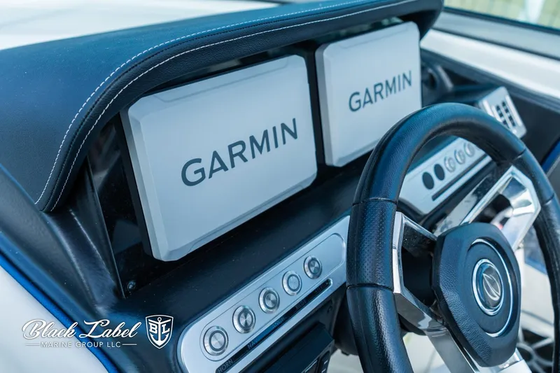 Slide: The Image of 2024 Crownline 260 XSS dashboard with dual Garmin displays and steering wheel. - 14