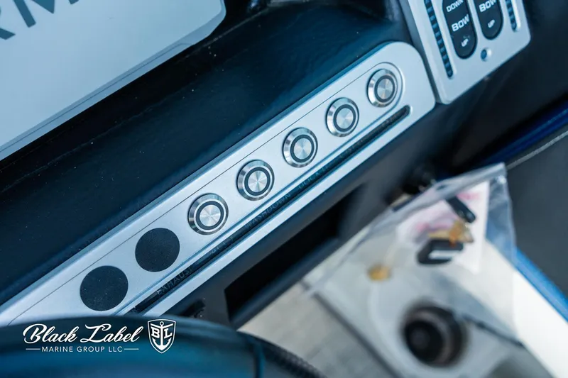 Slide: The Image of Control panel of 2024 Crownline 260 XSS boat with buttons and switches. - 17