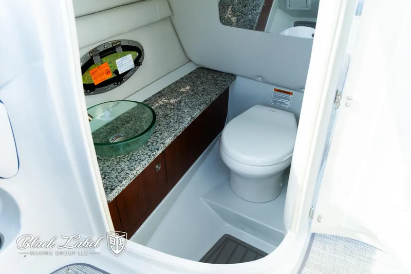 Slide: The Image of 2024 Crownline 260 XSS boat bathroom with granite countertop and modern fixtures. - 21
