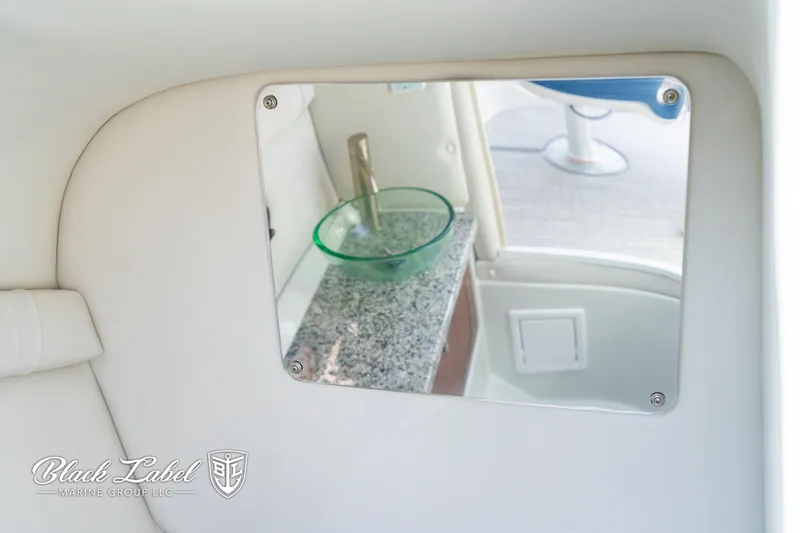 Slide: The Image of 2024 Crownline 260 XSS boat interior with mirror and granite countertop. - 23
