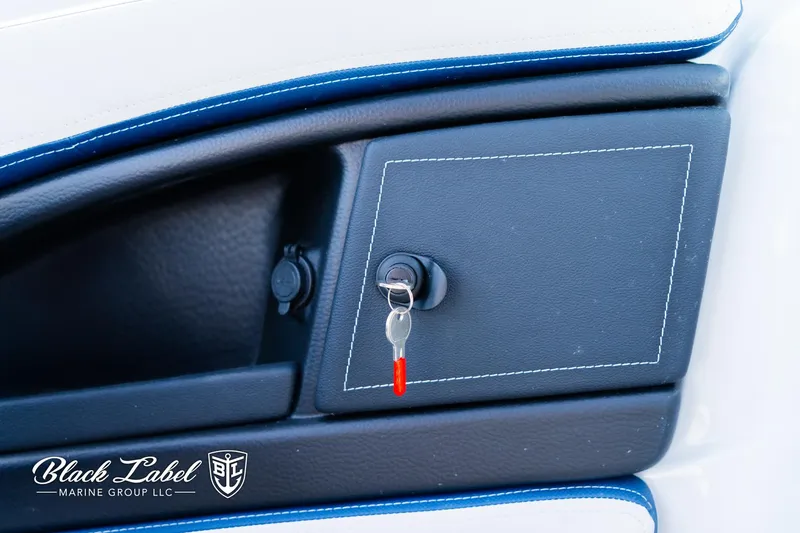 Slide: The Image of 2024 Crownline 260 XSS dashboard with key ignition, Black Label Marine Group branding. - 24