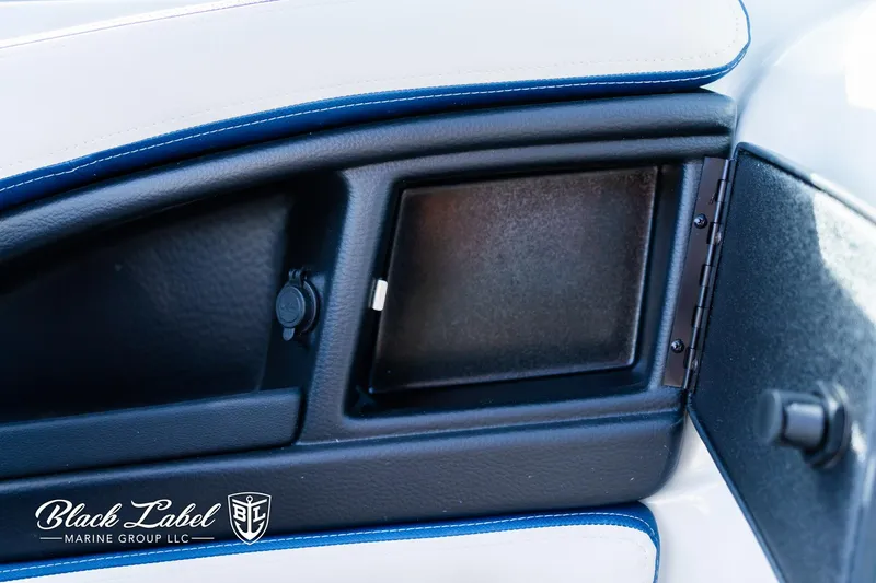 Slide: The Image of 2024 Crownline 260 XSS boat interior detail with storage compartment and sleek design. - 25