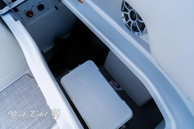 Slide: The Image of 2024 Crownline 260 XSS boat storage compartment with speaker and cooler. - 29