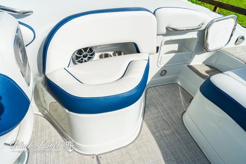 Slide: The Image of 2024 Crownline 260 XSS boat interior with white and blue seating, speaker, and storage compartments. - 30