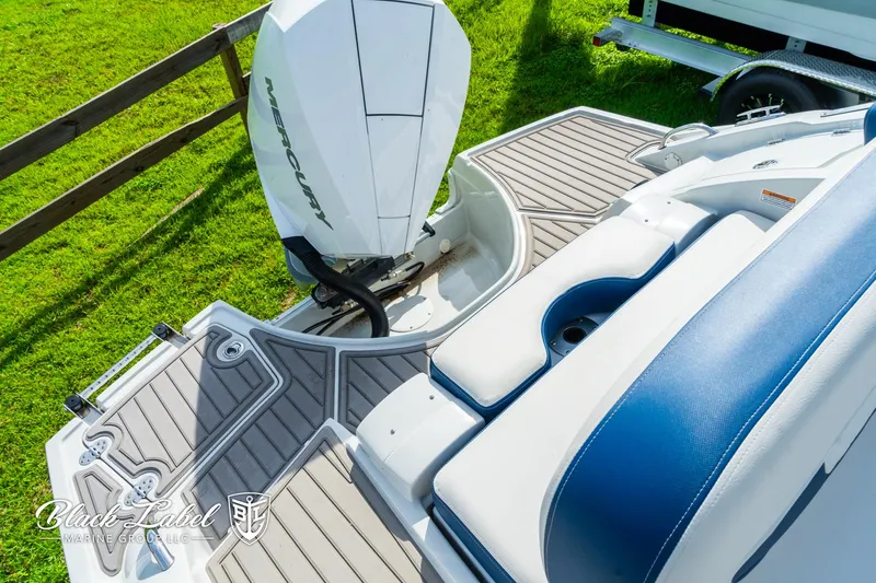 Slide: The Image of 2024 Crownline 260 XSS boat with Mercury engine, featuring sleek deck design. - 33