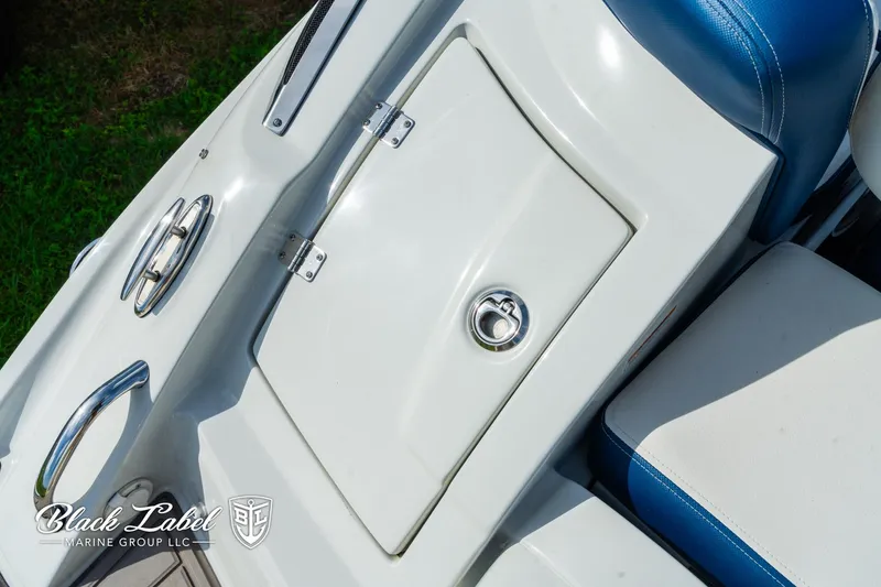 Slide: The Image of 2024 Crownline 260 XSS boat storage compartment with sleek design and blue seating. - 35