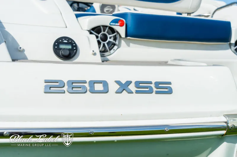 Slide: The Image of 2024 Crownline 260 XSS boat, close-up of model name and seating area. - 38