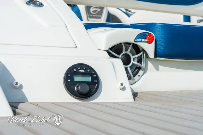 Slide: The Image of 2024 Crownline 260 XSS boat interior with audio system and blue seating. - 39