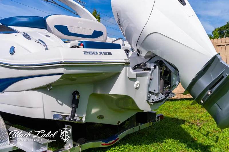 Slide: The Image of 2024 Crownline 260 XSS boat with powerful outboard motor, displayed on grass. - 40
