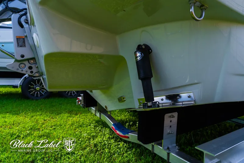 Slide: The Image of 2024 Crownline 260 XSS boat on trailer, displayed on grass. - 43