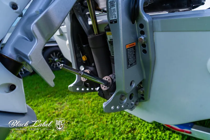 Slide: The Image of Close-up of 2024 Crownline 260 XSS boat engine components on grass. - 44