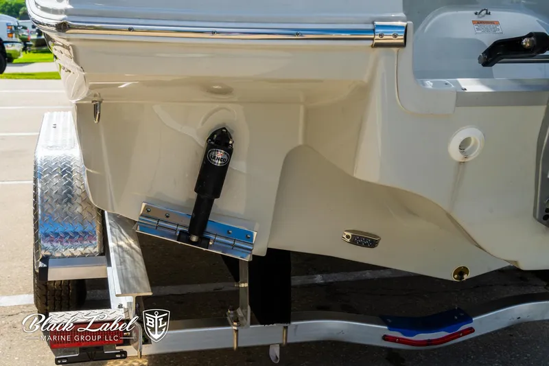 Slide: The Image of 2024 Crownline 260 XSS boat on trailer, rear view, Black Label Marine Group logo. - 5