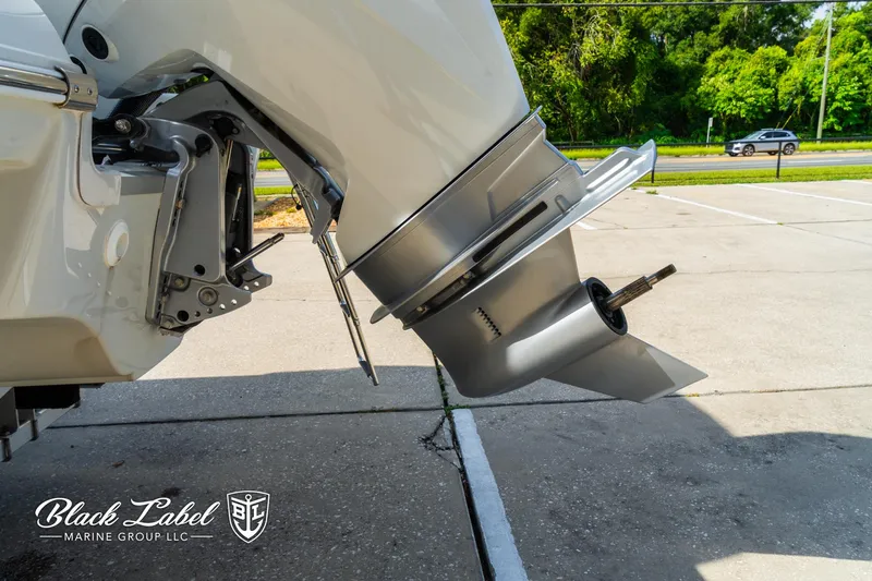Slide: The Image of 2024 Crownline 260 XSS boat engine detail in a parking lot. - 7