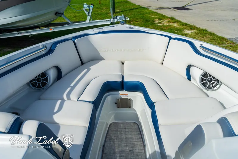 Slide: The Image of 2024 Crownline 260 XSS boat interior with white and blue seating, featuring built-in speakers. - 8