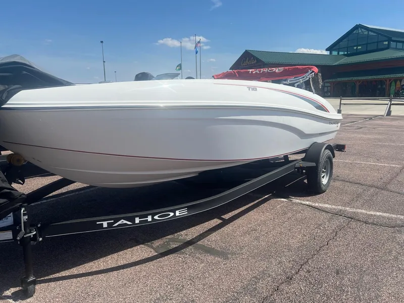 The Image of 2024 Tahoe T18 boat on trailer in parking lot, sunny day. - 0