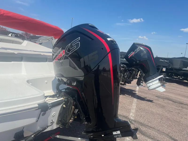 Slide: The Image of 2024 Tahoe T18 boat with powerful black and red outboard motors under a clear blue sky. - 2