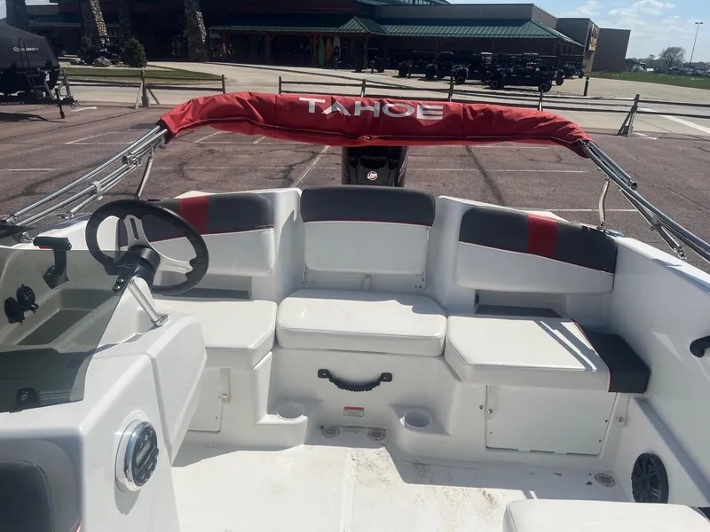 Slide: The Image of 2024 Tahoe T18 boat interior with seating and steering wheel, featuring red and gray accents. - 5