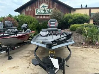 Slide: The Image of 2024 Ranger RT198P boat displayed outside RedHead store. - 2