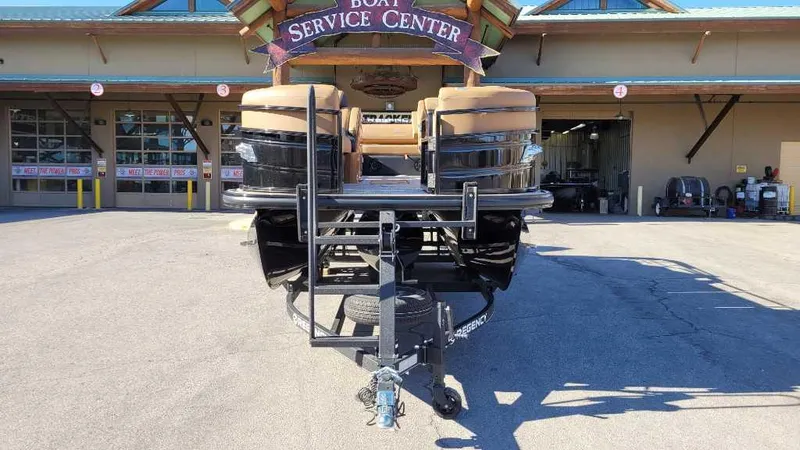 Slide: The Image of 2024 Regency 230 LE3 Sport boat at service center, front view. - 3