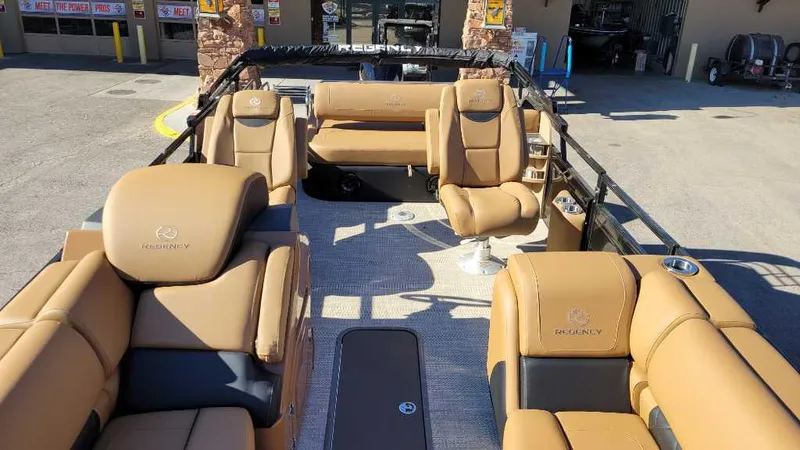 Slide: The Image of 2024 Regency 230 LE3 Sport pontoon boat with luxurious tan seating and spacious layout. - 6
