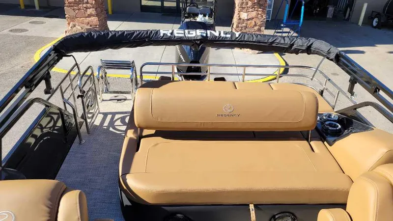 Slide: The Image of 2024 Regency 230 LE3 Sport boat with tan seating and sleek design. - 9