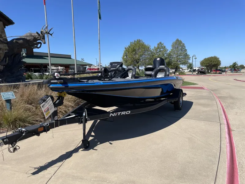 Slide: The Image of 2024 Nitro Z19 boat on trailer, parked outdoors on sunny day. - 1