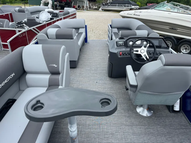 Slide: The Image of 2024 Bennington 188 SVL pontoon boat interior with gray seating and helm station. - 13